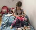 Alisa, 5, plays with teddy bears in the bedroom of a Warsaw apartment provided to the family by the Habitat for Humanity Poland Foundation together with the city of Warsaw. Preparing to flee Ukraine, the girl's mother said she could take to ple