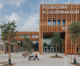 The school's wooden facade reflects the symbiosis of modern architecture with the natural surroundings of the Merimetsa forest