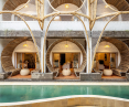 Facade of the hotel made of bamboo and wood, overlooking the pool