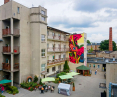 A floral mural on the DPS building at 28 Pułku Strzelców Kaniowskich has enlivened a gray neighborhood