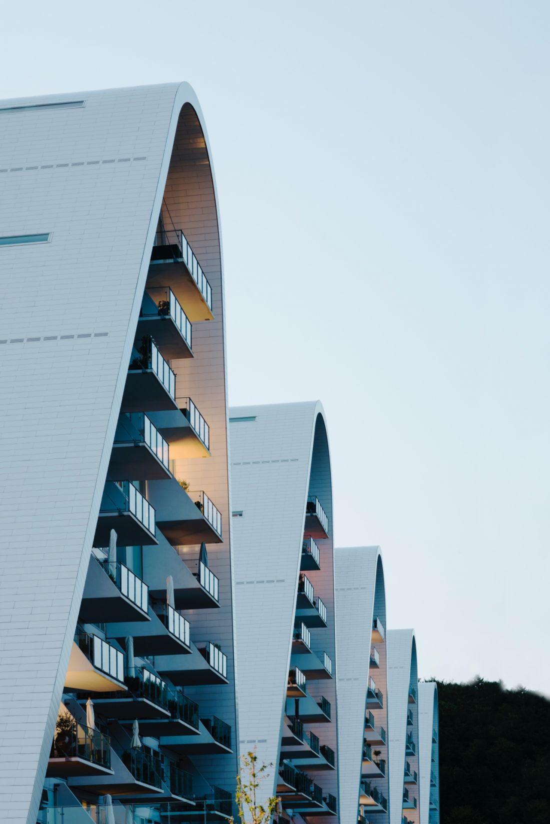 Kompleks apartamentowy The Wave w Vejle, w Danii - boczne elewacje wież są gładkie i pionowe, zdominowane przez wielkoformatowe przeszklenia