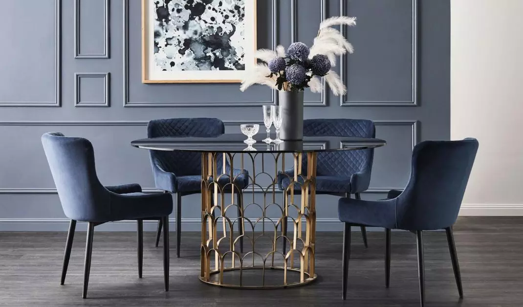 Quilted upholstery of chairs and a table on an ornate leg, typical of the glamour style