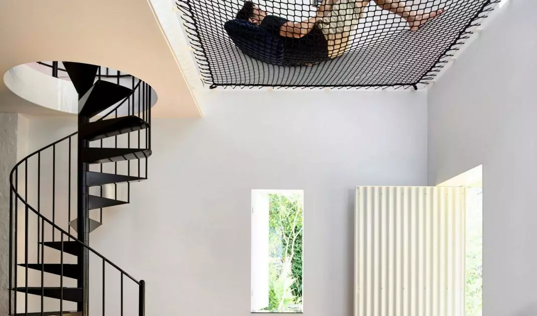 Hammock net stretched between the mezzanine and the outer wall of the building