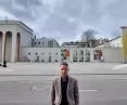 Councilman Tomasz Dzionek against the background of the almost treeless square in front of the Fredro Theatre in Gniezno