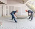 Installation of an additional 10 mm thick fermacell® gypsum-fiber board, which is glued and screwed as a cover for the fermacell® Therm 25 underfloor heating system