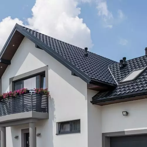 How does a gutter system affect the aesthetics and functionality of buildings?