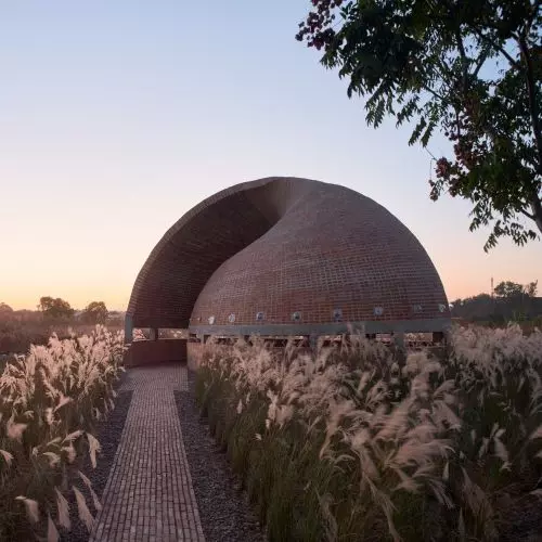 Brick library in the shape of a spiral shell - a hybrid of contemporary form and traditional matter