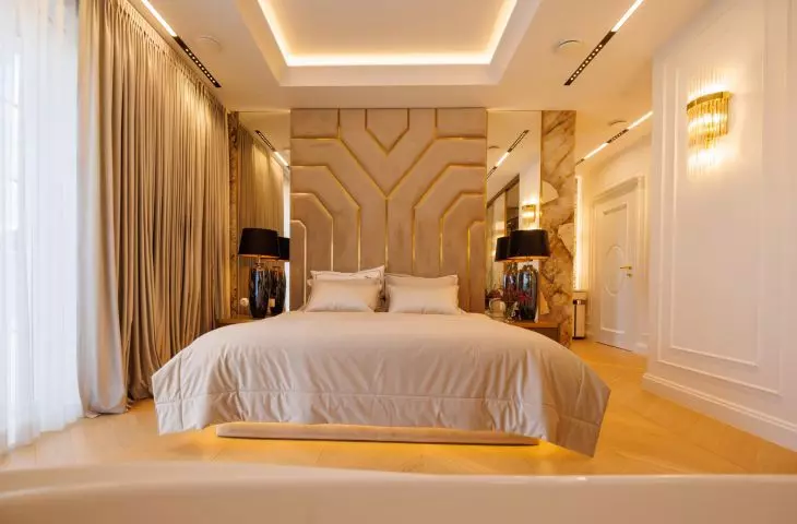 Master bedroom in gold and stone. New York style arrangement