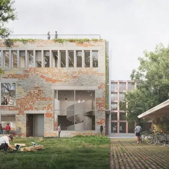 widok na zielone wnętrze urbanistyczne oraz na elewację frontową budynku zbiorów