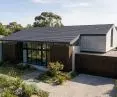 The flat profile of swissporTON's KAPSTADT tile creates a smooth, almost monolithic slope on the roof