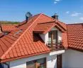 The natural red hue of swissporTON ceramic roof tiles, which age gracefully and exist in perfect harmony with the surrounding natural environment