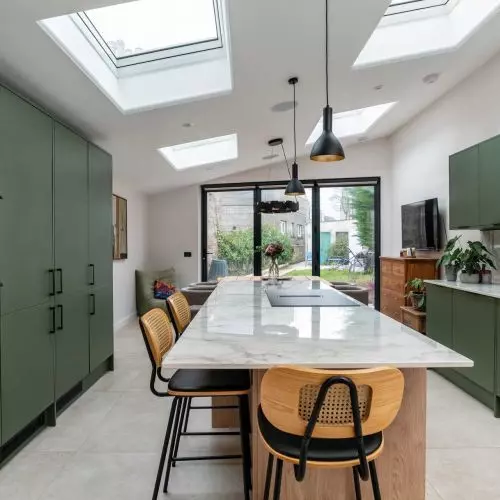 More light despite dense development. Home expansion using windows for flat roofs