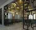 A black Volak-style Nordic room divider in a restaurant