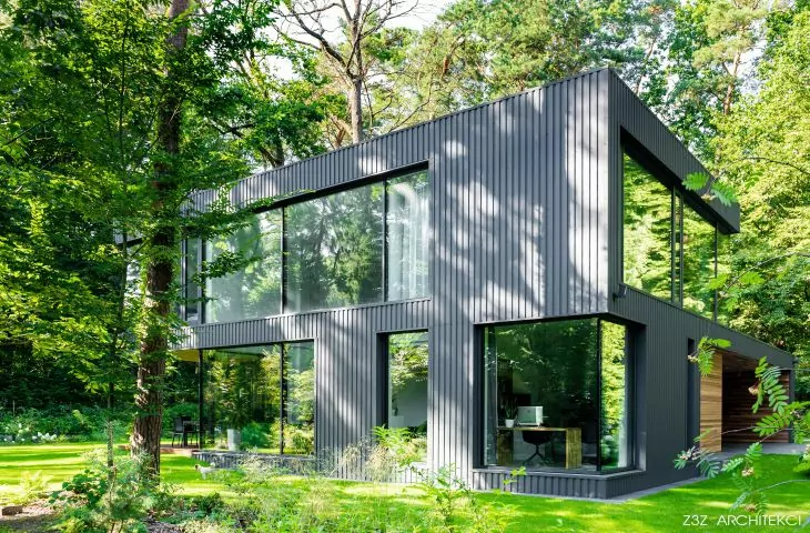 Black house in a green forest landscape designed by Z3Z Architects