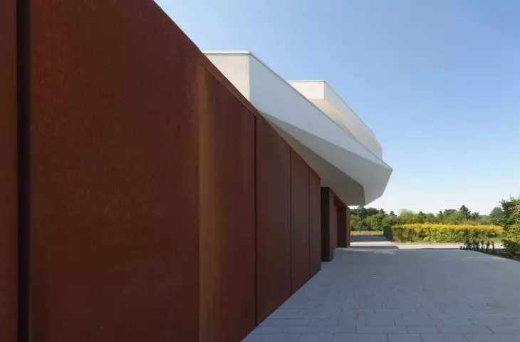 Wuzetka house, layers of sponge cake and cream were replaced with contrasting plaster and corten