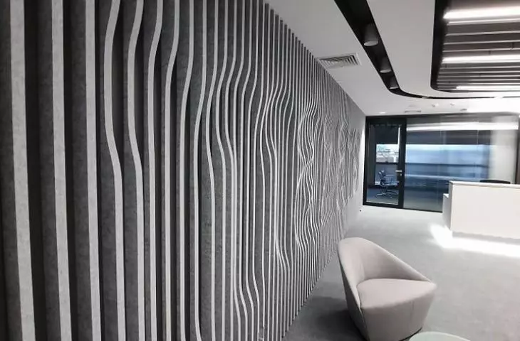 Acoustic wall of felt fins with embossed logo