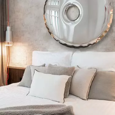 The wall behind the bed was decorated with a special plaster
