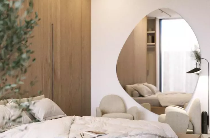 The interior features a large mirror with an organic shape