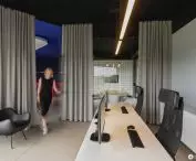 Office area, conference room in the background with a wall lined with dish pads