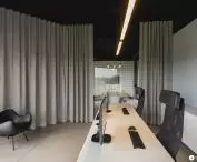 Biuro FORMSON, w tle sala konferencyjna ze ścianą wyłożoną podkładkami pod naczynia