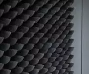 Thousands of evenly stacked black spatulas form a wall