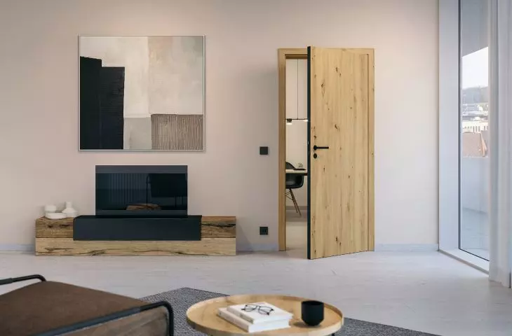 BaseLine rebate-free wooden door, with structured Duradecor surface in light oak and board edge in black and LineaPlanar black.edition handle