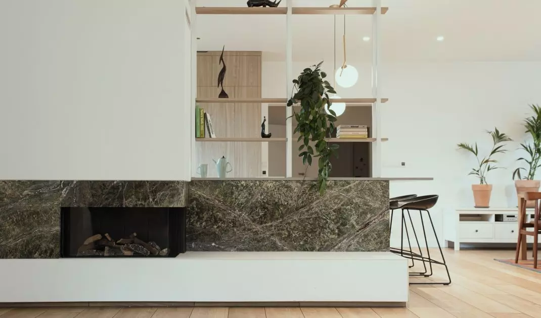 The kitchen island and fireplace are joined by marble