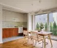 The center of the apartment is an open living room with a dining room
