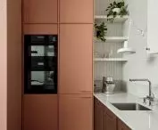 peach-colored cabinetry complements the kitchen interior