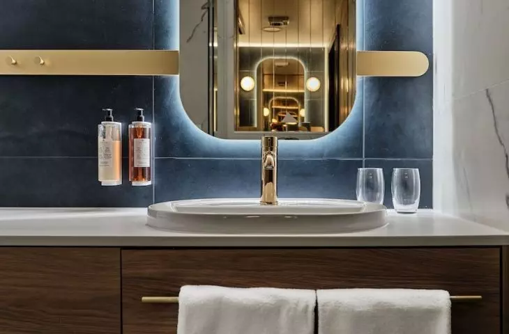 All bathrooms are characterized by gold accessories