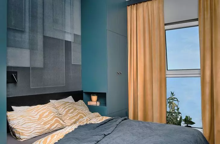 Complementing the color palette of the bedroom are honey-colored curtains