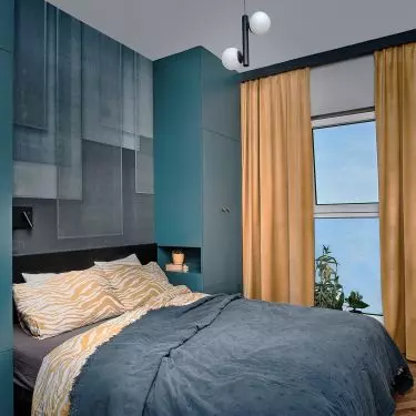 Complementing the color palette of the bedroom are honey-colored curtains