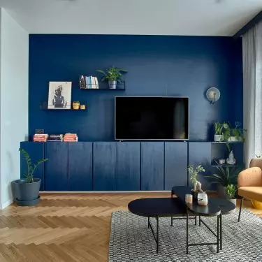 The living room area's cabinetry has been painted blue