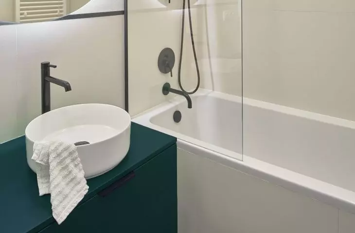 On the walls and floor of the bathroom there is stoneware