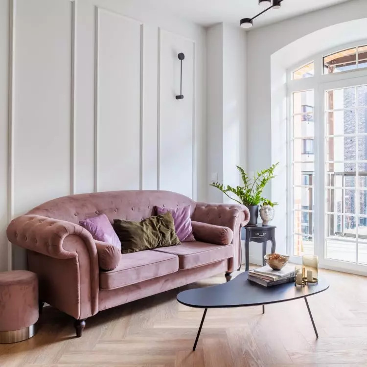 The focal point of the living room is a sofa in a dirty pink color