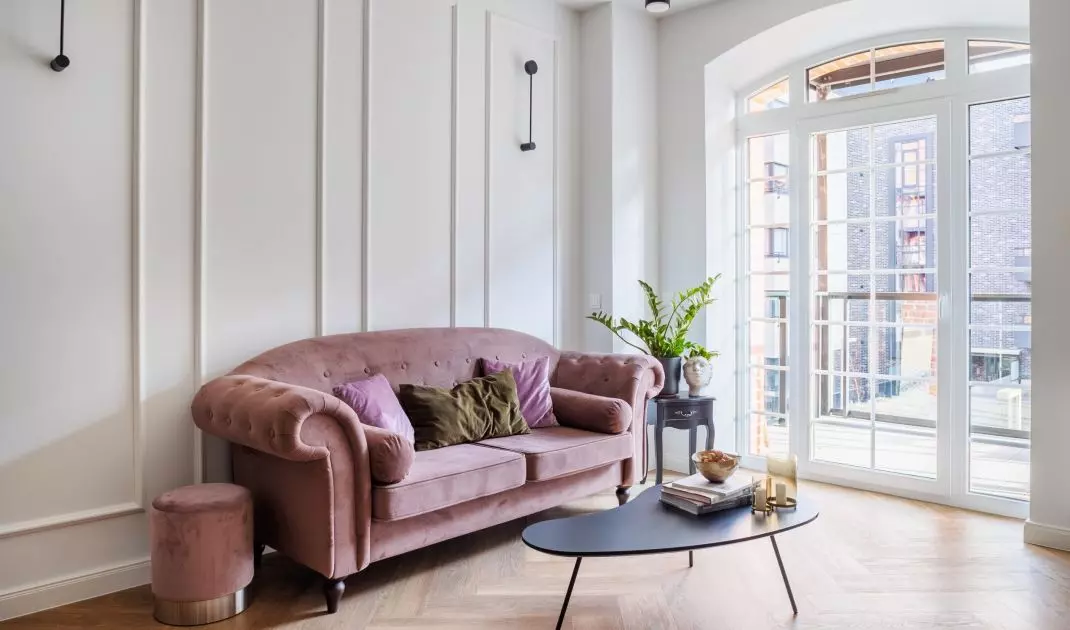 The focal point of the living room is a sofa in a dirty pink color