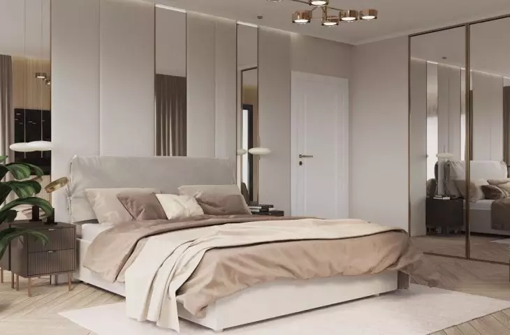 The bedroom has mirrors on two walls