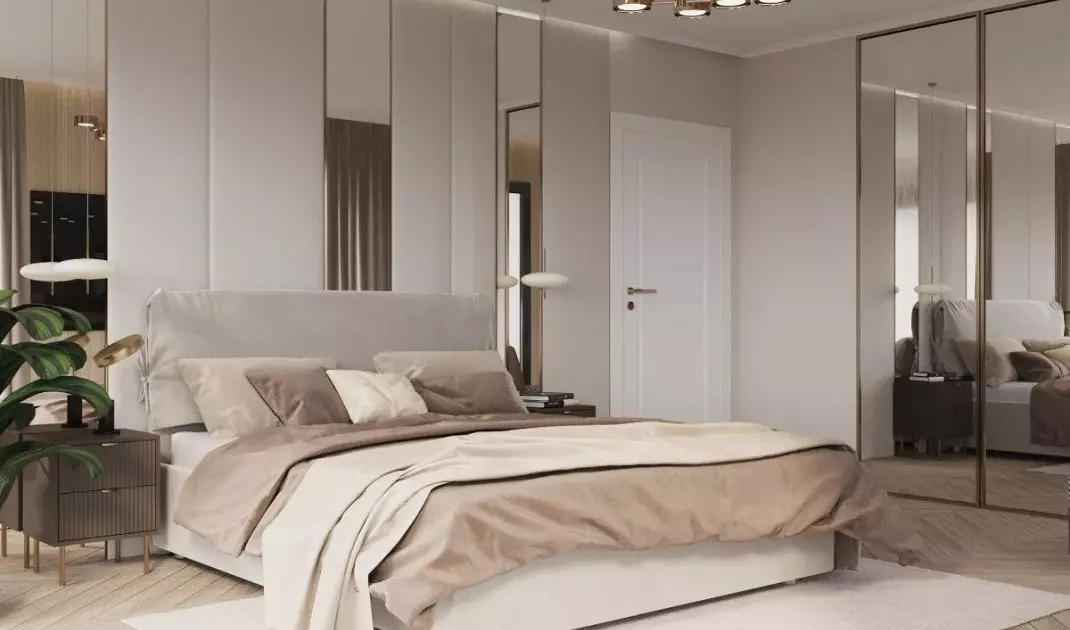 The bedroom has mirrors on two walls