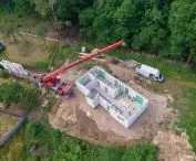 Installation of the walls of the house in the heavy German system; it takes about a week to put the shell of the house closed (on a previously prepared foundation slab)