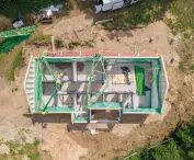 Installation of the walls of the house in the heavy German system; it takes about a week to put the shell of the house closed (on a previously prepared foundation slab)