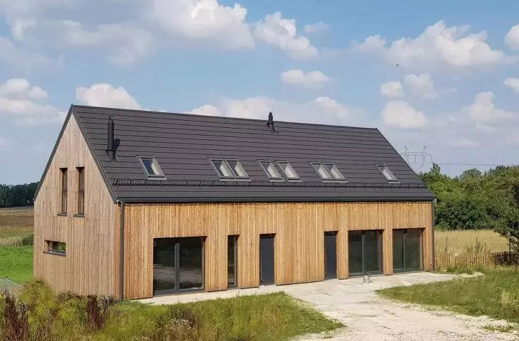 A modern barn-type house built using precast concrete technology; the choice of technology does not limit what material will be on the facade