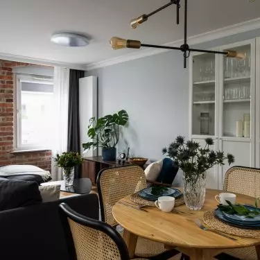 The dining area features Viennese plaid chairs