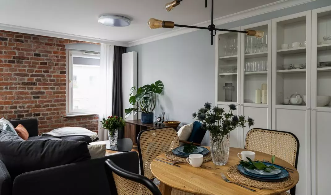 The dining area features Viennese plaid chairs