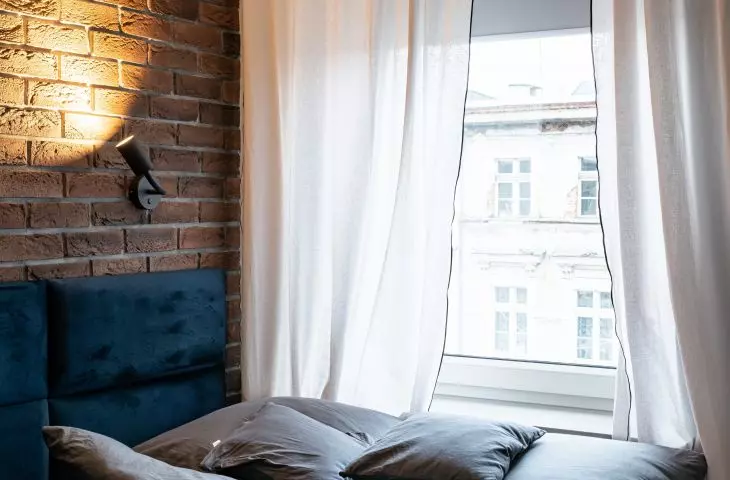 In the bedroom there is an upholstered bed