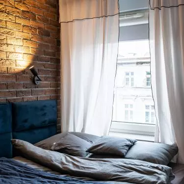 In the bedroom there is an upholstered bed