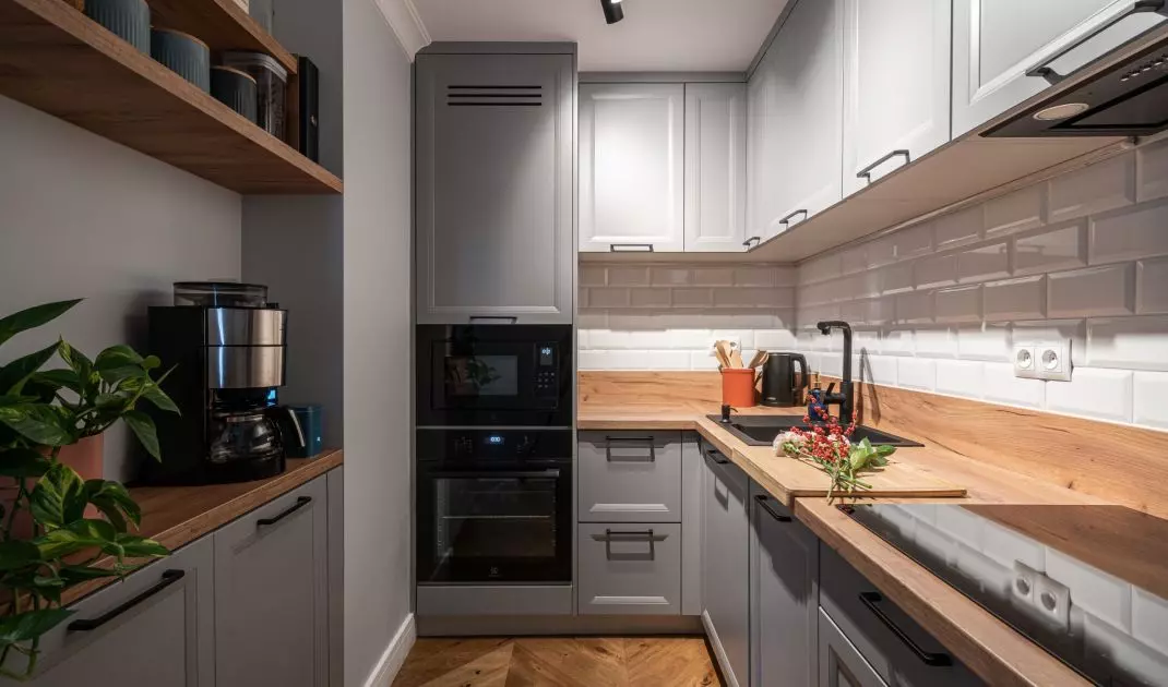 The kitchen is decorated in gray colors 