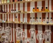 niszowe perfumy stoją na mosiężnych półkach