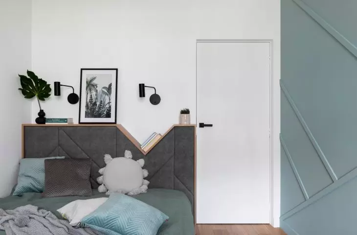 The bed headrest also functions as a nightstand