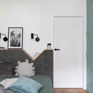 The bed headrest also functions as a nightstand