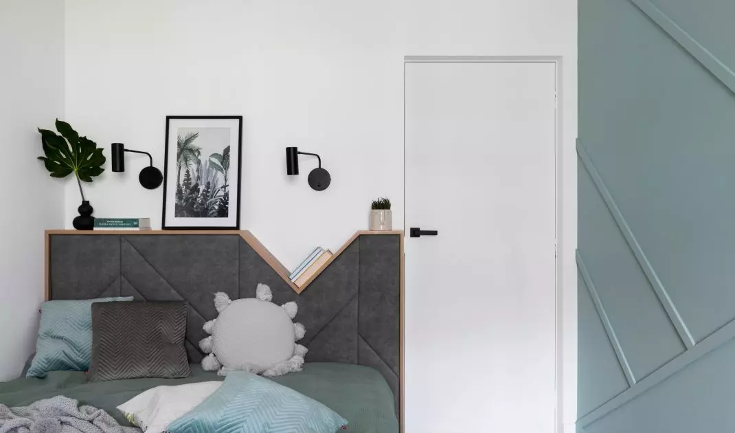 The bed headrest also functions as a nightstand